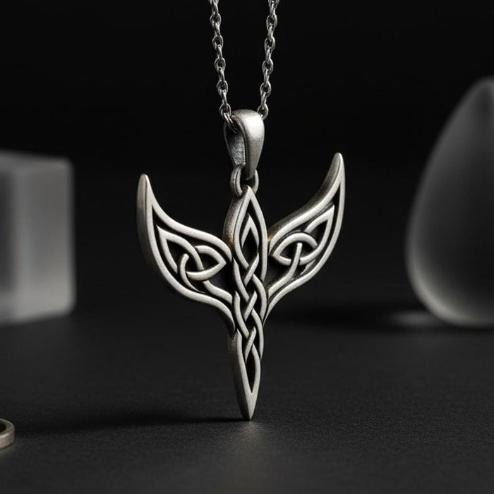 Close-up of the Celtic Wing Knot Necklace showing openwork wings and a vertical interlaced center knot