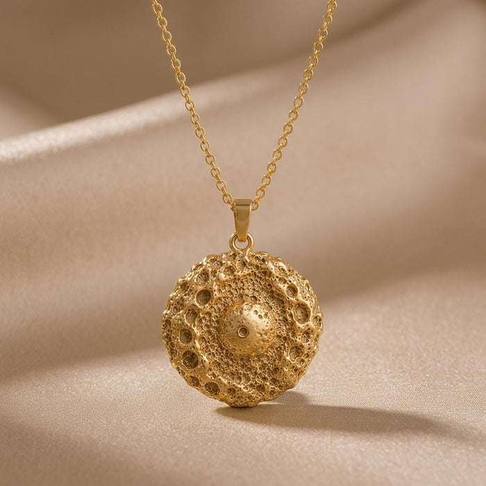 Gold Plated Silver Ceres asteroid pendant necklace with a crater-textured round pendant on champagne satin
