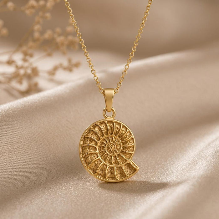 Gold Plated Silver ammonite fossil pendant necklace on champagne satin