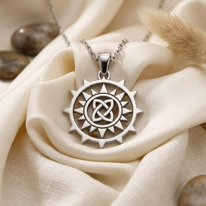 Close-up of the Circle Knot Necklace pendant with an open interlaced center on ivory fabric