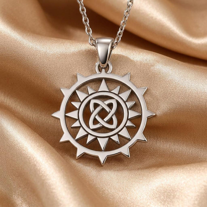 Detailed view of the Circle Knot Necklace pendant on gold satin