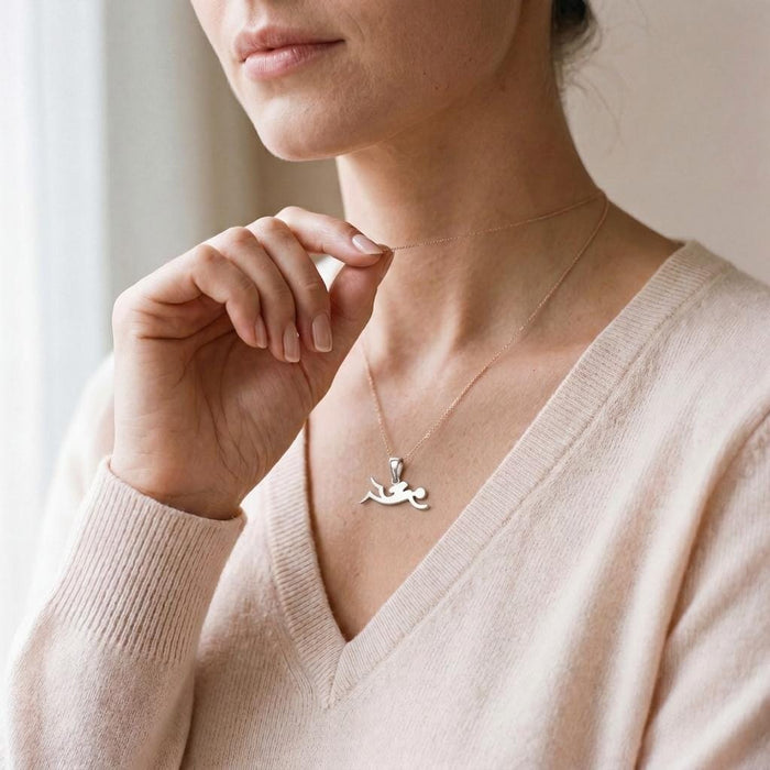 Diver Silver Necklace worn with a pale knit V-neck sweater
