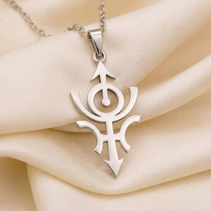 Close view of the Cosmic Nibiru openwork pendant on cream satin