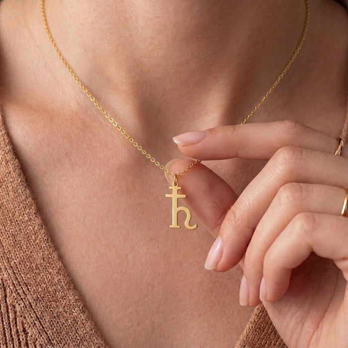 Gold Plated Silver Saturn Symbol Necklace worn close to the neckline