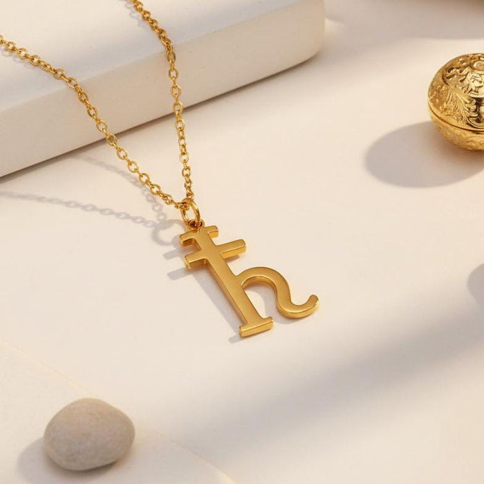 Gold Plated Silver Saturn glyph pendant displayed on a chain