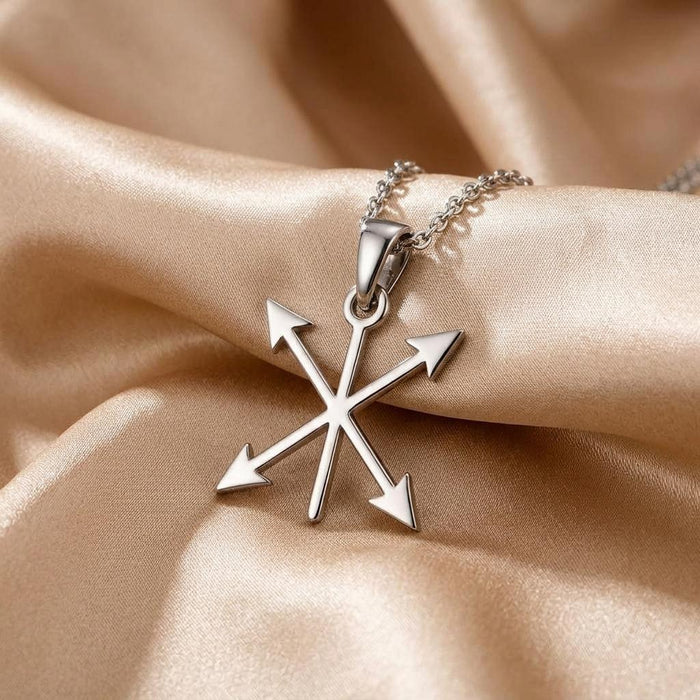 Four-arrow pendant with pointed arrowheads displayed on champagne satin