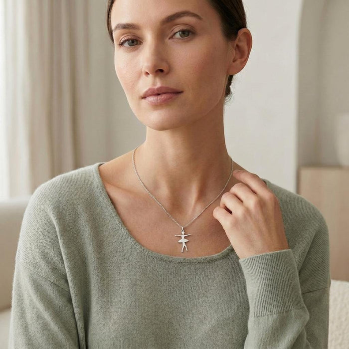 Crossed-feet Ballet Dancer Necklace worn with a soft green scoop-neck sweater