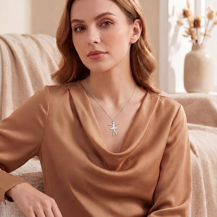 Crossed-feet Ballet Dancer Necklace worn with a bronze satin draped blouse