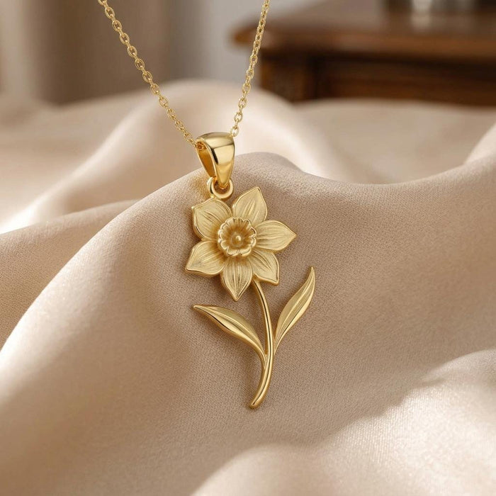Close view of a Gold Plated Silver daffodil pendant with engraved petals and raised center