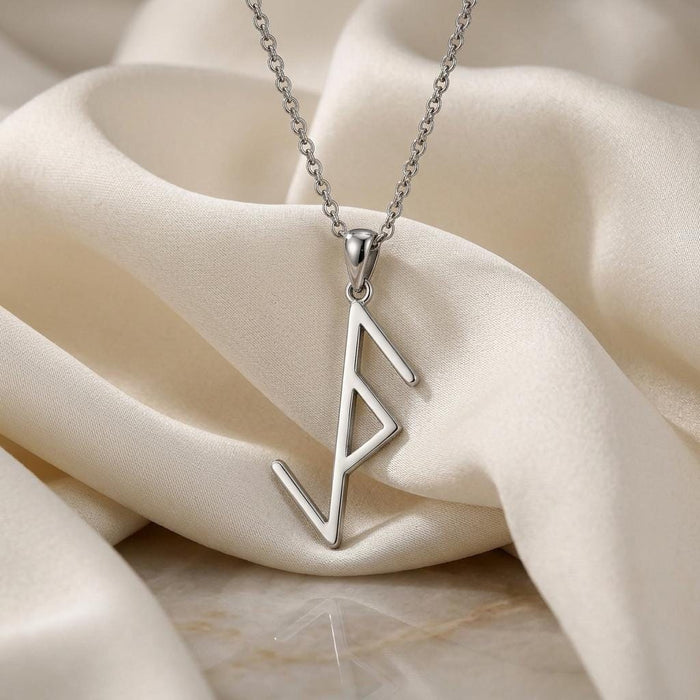 Silver Viking Protection Rune Necklace with open diamond rune detail on ivory fabric