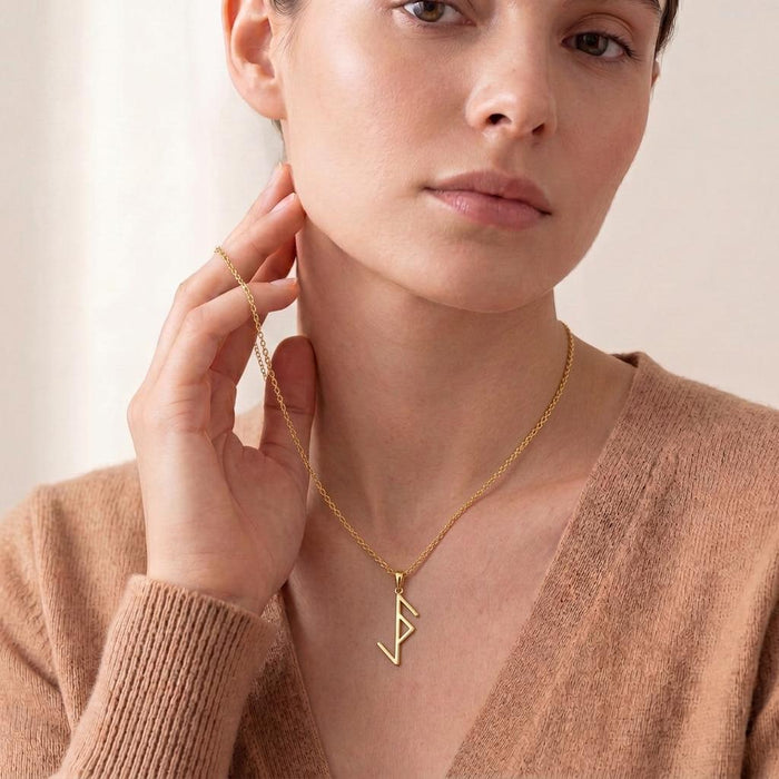 Gold-tone Viking Protection Rune Necklace worn with a brown V-neck knit top
