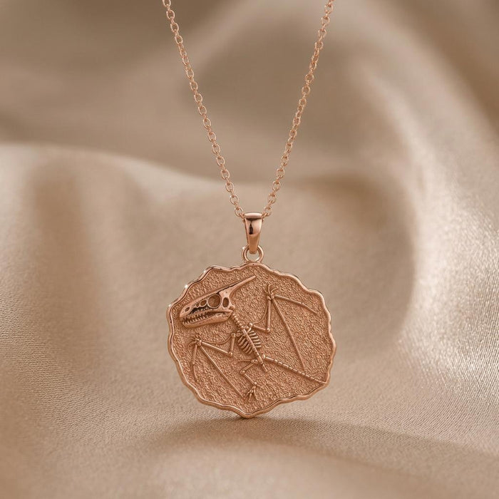 Rose Gold Plated Dimorphodon Fossil Pendant with a textured scalloped fossil medallion