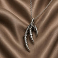 Silver Dragon Claw Pendant Necklace with three articulated talons on bronze satin