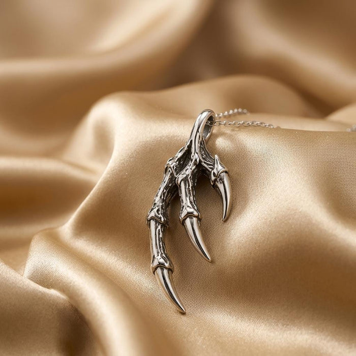Silver Dragon Claw Pendant Necklace with segmented talons on champagne satin