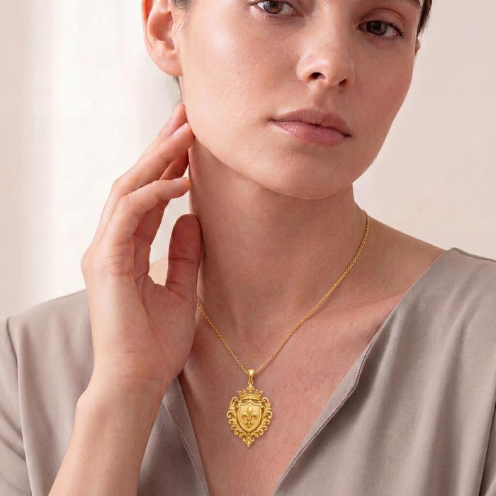 Dynasty Emblem Necklace in Gold Plated Silver worn with a satin V-neck blouse