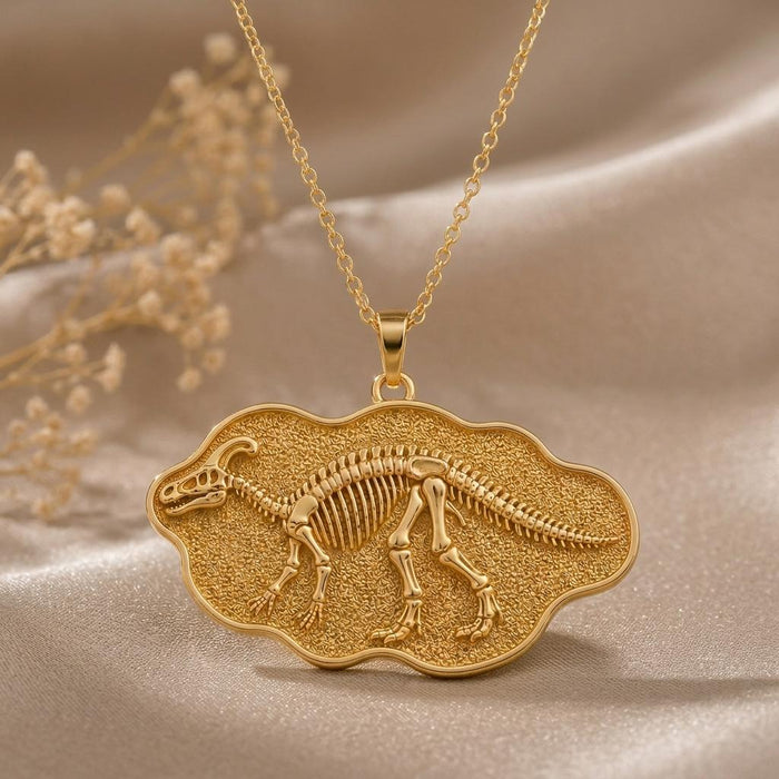 Close-up of a Gold Plated Silver Edmontosaurus skeleton relief on a textured scalloped plaque