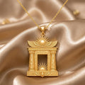 Gold Plated Silver Egyptian Solar Gate pendant necklace with an open rectangular center on champagne satin