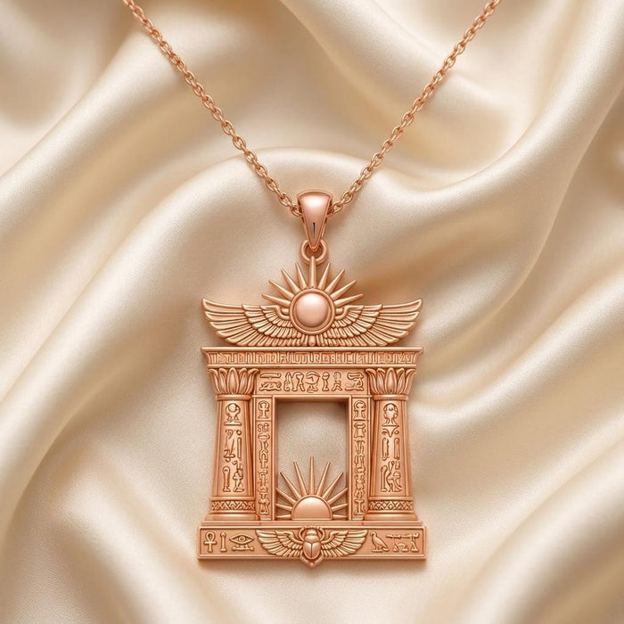 Rose Gold Plated Egyptian Solar Gate pendant necklace with an open rectangular center on draped ivory satin