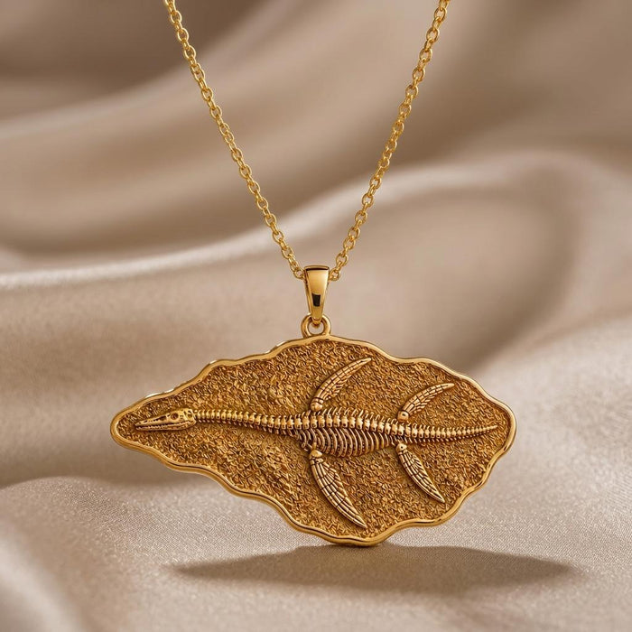 Close-up of a Gold Plated Silver Elasmosaurus Fossil Pendant showing the raised skeleton relief