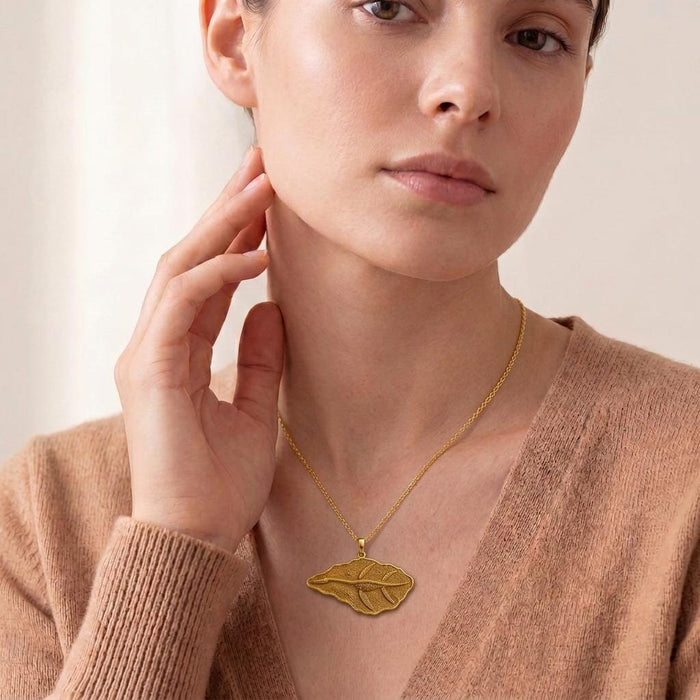 Model wearing a Gold Plated Silver Elasmosaurus Fossil Pendant at the collarbone