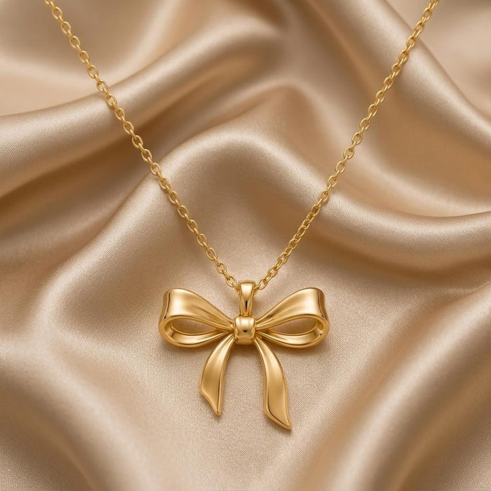 Gold Plated Silver Elegant Bow Pendant Necklace with sculpted open loops on champagne satin