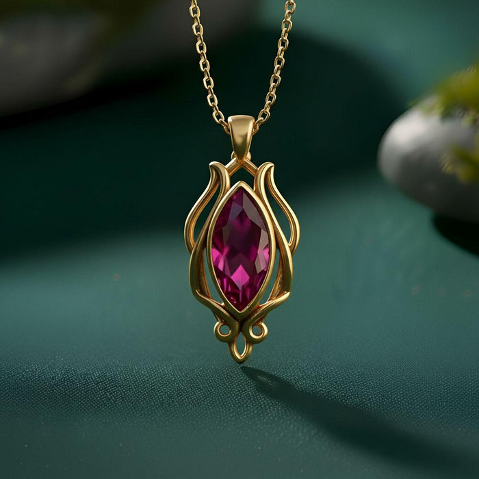 Gold Plated Silver Elven Forest Birthstone Necklace with a magenta marquise-shaped stone and curved openwork scrollwork pendant on a dark green background