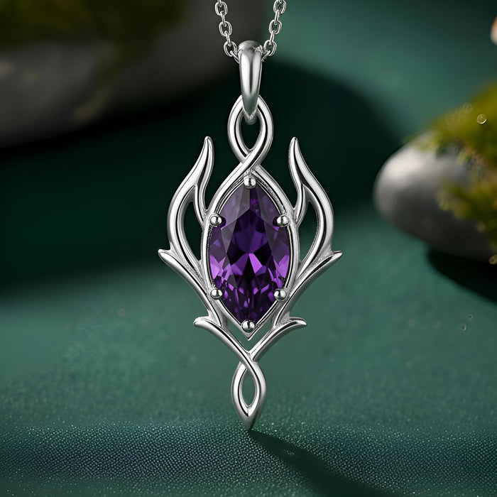 Silver Elven Marquise Birthstone Necklace with a purple marquise-shaped stone on deep green fabric