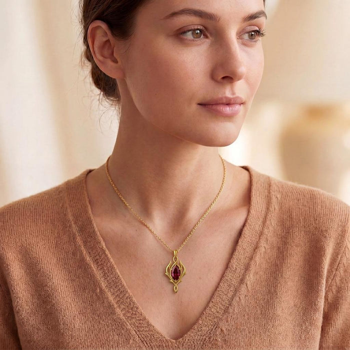 Gold Plated Silver Elven Marquise Birthstone Necklace with a red marquise-shaped center stone worn with a V-neck knit top