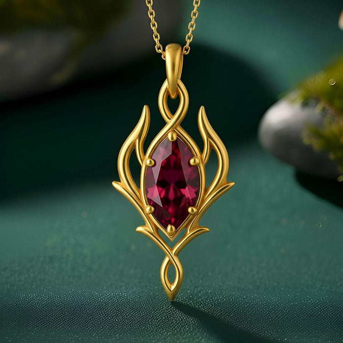 Gold Plated Silver Elven Marquise Birthstone Necklace with a deep red marquise-shaped stone on green fabric