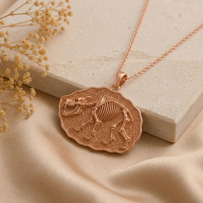 Rose Gold Plated Entelodon Fossil Pendant Necklace on stone beside dried flowers