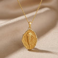 Gold Plated Silver Eurypterid Fossil Pendant Necklace with a raised segmented relief on champagne satin