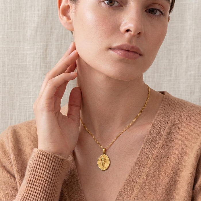 Close-up of a model wearing a Gold Plated Silver Eurypterid Fossil Pendant Necklace