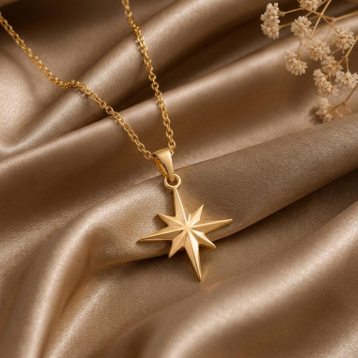 Angled close-up of the Gold Plated Silver North Star pendant on champagne satin