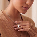 Fitness Woman Pendant Necklace worn with a tan knit sweater, showing a kneeling figure holding two dumbbells