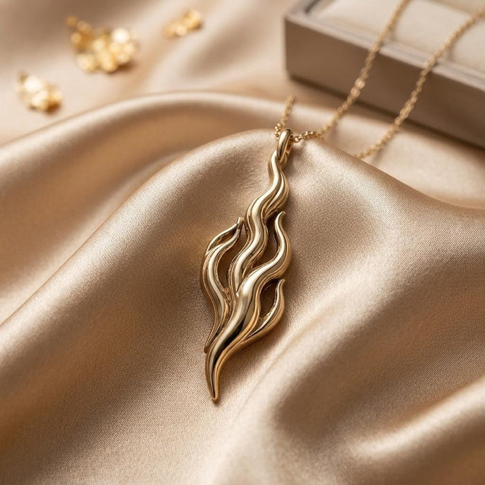 Gold Plated Silver Flame of Venus pendant necklace with layered openwork flame lines on champagne satin