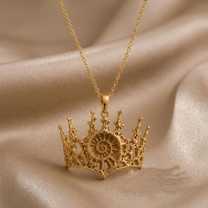 Gold Plated Silver Fossil Crown Necklace with openwork crown pendant and raised spiral fossil-inspired center on champagne satin
