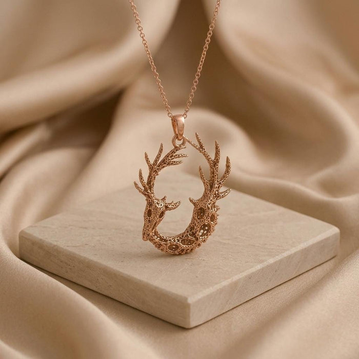Rose Gold Plated Fossil Deer Relic pendant with paired deer profiles on a square stone block