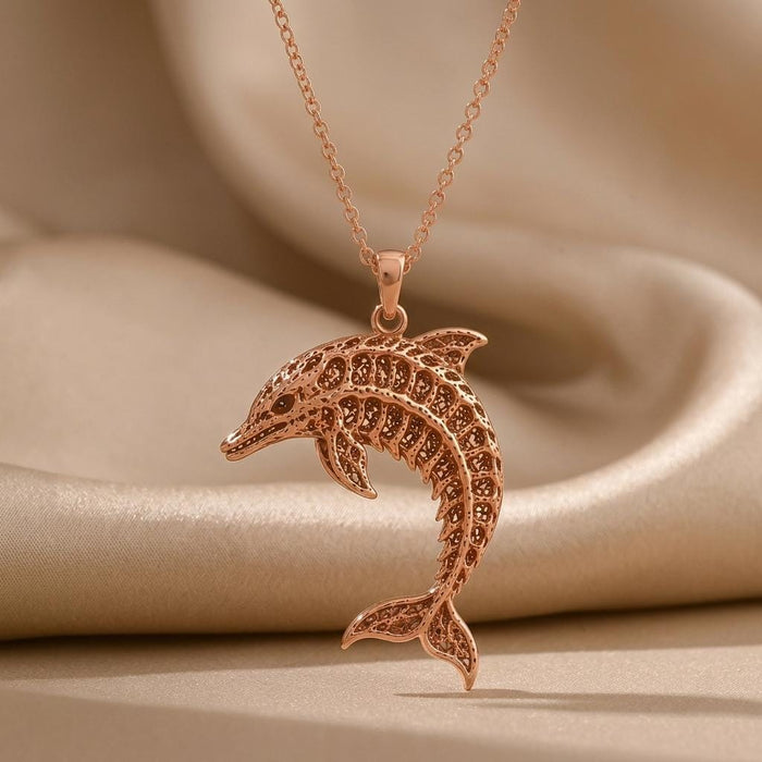 Rose Gold Plated Fossil Dolphin Artifact Necklace with a detailed openwork leaping dolphin pendant on champagne satin