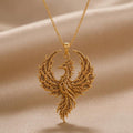 Gold Plated Silver Fossil Phoenix Crest Necklace with textured wings on beige draped fabric