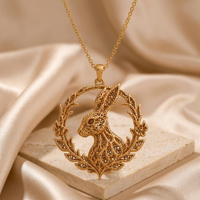 Close view of the Fossil Rabbit Halo pendant with pointed leaves, lower flowers, and textured rabbit profile