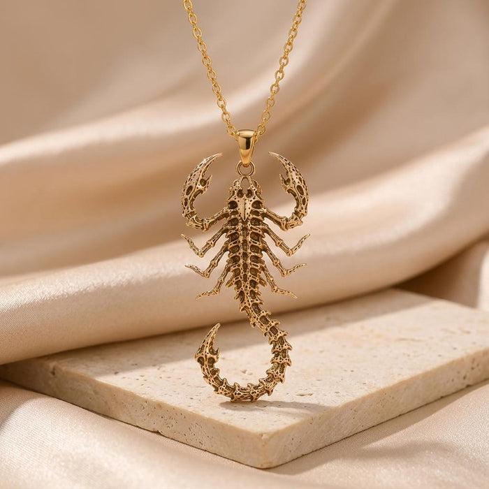 Front view of Gold Plated Silver Fossil Scorpion Spine pendant with openwork claws and curled tail