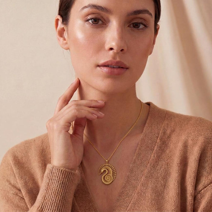 Model wearing the Gold Plated Silver Fossil Swan Halo Pendant Necklace with a neutral knit top