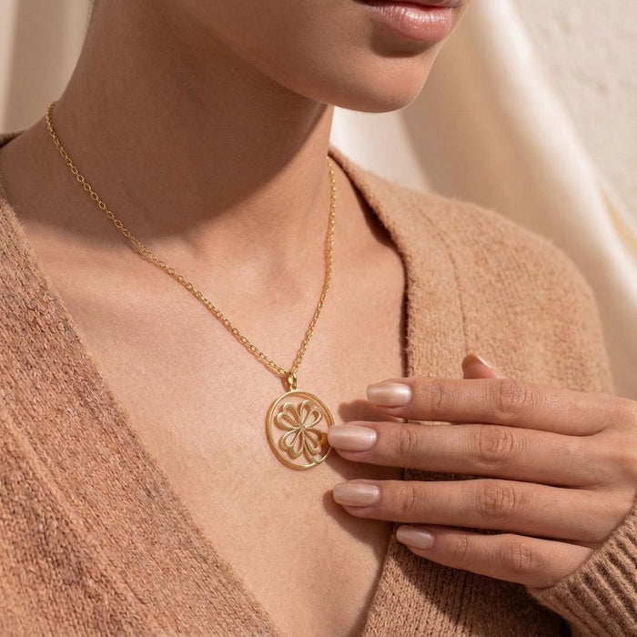 Gold Plated Silver Four Leaf Clover Necklace worn with a textured beige V-neck sweater