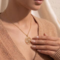 Gold Plated Silver Four Leaf Clover Necklace worn with a textured beige V-neck sweater