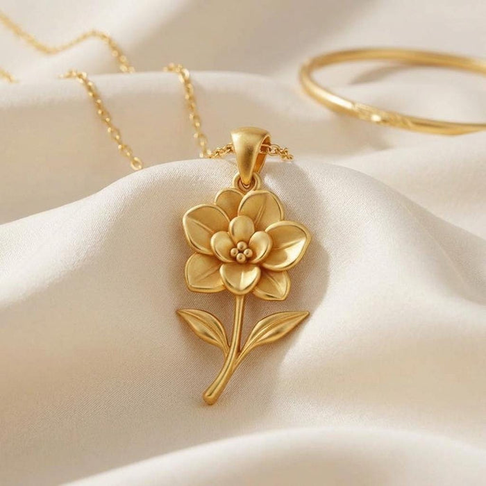 Gold Plated Silver Gardenia Flower Necklace with layered petals displayed on cream satin
