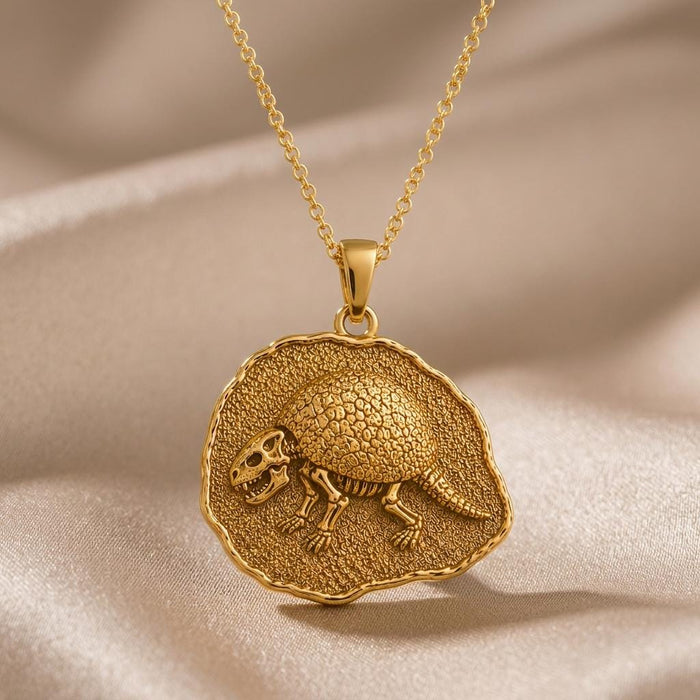 Gold Plated Silver Glyptodon fossil medallion necklace on champagne satin