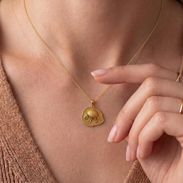 Gold Plated Silver Glyptodon fossil pendant necklace worn at the collarbone