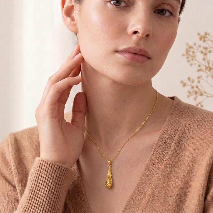 Model wearing the Gold Meteor Core Necklace in Gold Plated Silver with a neutral knit top
