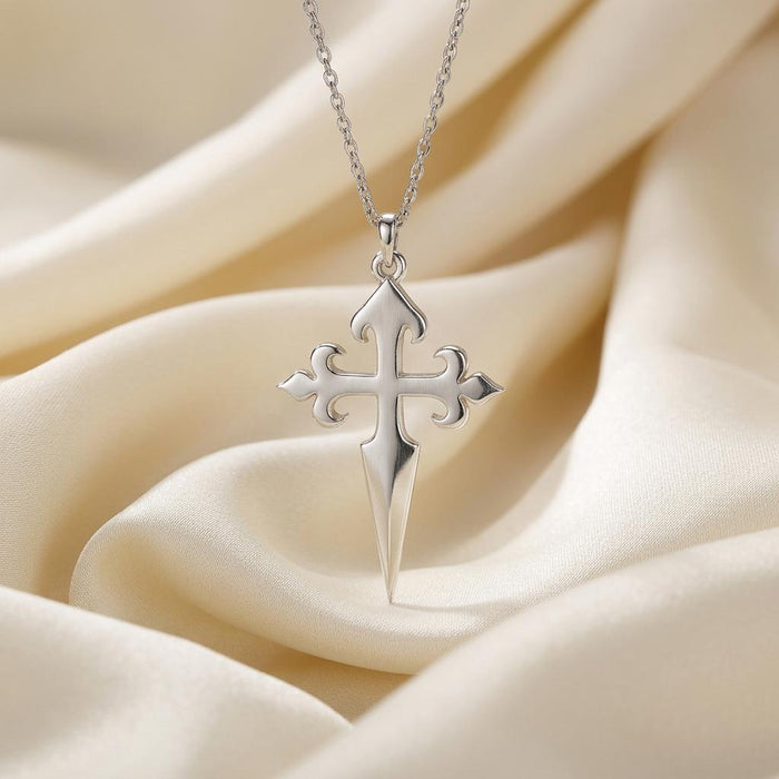 Front close-up of the pointed Gothic Cross Dagger pendant on ivory satin
