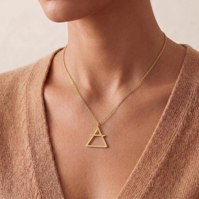 Front neckline view of the Air Element Necklace with an upright triangle and horizontal bar pendant